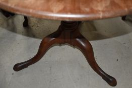 A Georgian mahogany tripod table having birdcage support on turned column and triple splay legs