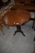 A 19th Century mahogany pedestal occasional table having shaped top , turned column and triple splay