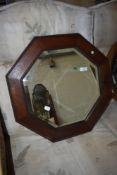 An early 20th Century wall mirror having oak octagonal frame, width approx. 54cm