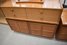 A Nathan teak low sideboard unit with double cupboard under four drawers, width approx. 102cm