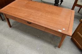 A modern teak effect coffee table, approx. 122 x 61cm