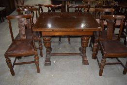 An early 20th Century oak drawer leaf dining table and set of four chairs, with bulbous frame
