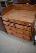 A Victorian pine or deal washstand having shaped ledge back , one shallow over two short and two