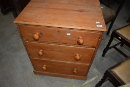 A stripped pine chest of three long drawers, width approx.64cm