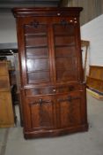 A Victorian mahogany bookcase comprising glazed section having scroll and foliate embellishments and