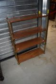 A mid century shelf unit with brass frame and Mahogany shelves.