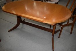 A Parker Knoll oval extending dining table with 'whale tail' style legs , and set of six (four