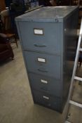 An industrial style four drawer metal filing cabinet