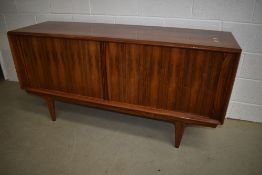 A nice quality vintage rosewood sideboard having sliding doors and stylised frame CITES