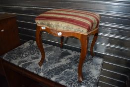 An early 20th century piano stool with cabriole legs and shaped frame.