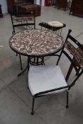 A patio set comprising two armchairs and circular table, having powder coated frames and mosaic
