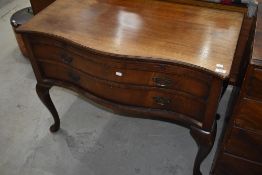 A Victorian bachelor desk having two under drawers with pull out desk top having serpentine front on