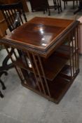 An Edwardian mahogany revolving bookcase having typical inlay decoration, some splitting to top