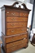 A 19th Century mahogany chest on chest having broken pediment over two over three drawer top