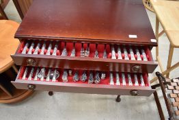 A reproduction mahogany effect canteen on legs containing two drawers of Arthur Price cutlery