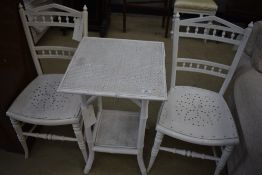 A pair of Victorian bedroom chairs and a wicker occasional table, both being white overpainted