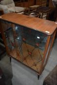 A 1950s glazed china cabinet on dansette style legs