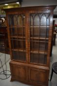 A reproduction mahogany bookcase with glazed top over cupboard base, height approx. 186cm