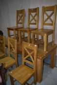 A modern gold oak kitchen dining table and set of six chairs