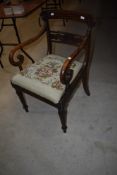 A Victorian carver chair having simulated Rosewood stained beech frame with carved back and scroll