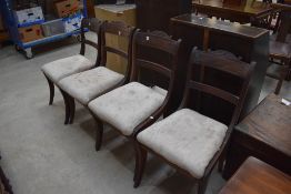 A set of four 19th Century mahogany dining chairs , Regency design having sabre style legs