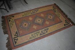 A vintage rug in the aztec style design
