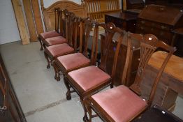 A set of six early 20th century mahogany dining chairs having railed back with cartouche and rosette
