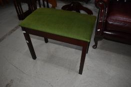 A modern mahogany frame piano stool having dralon lift up seat