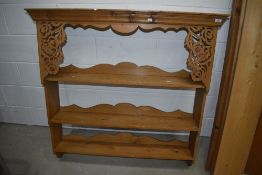 A modern pine delft rack having foliate fretwork decoration, width approx 115cm