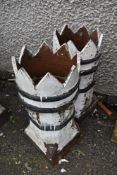 A pair of traditional painted chimney pots with crown tops
