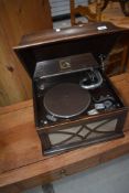 An early 20th Century oak cased HMV gramophone including winding handle and needles