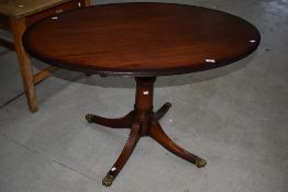 An interesting reproduction Regency style coffee/dining table having adjustable height mechanism,