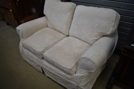 A modern cream two seater settee