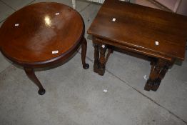 A 1930's circular walnut occasional table, sold along with a nest of two oak occasional tables