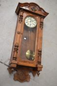 A 19th Century mahogany and walnut wall clock , having roman numeral enamelled dial, with two
