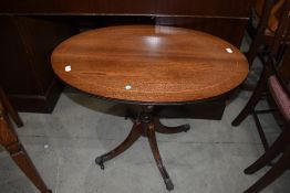 A reproduction Regency style oval top coffee table