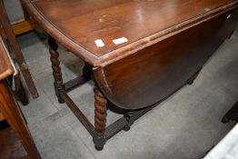 An early to mid 20th Century oak twist gate leg dining table