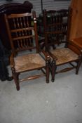 A 19th Century vernacular spindle back chair having rush seat