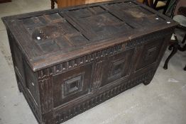 A 17th Century and later oak kist in the Jacobean style having typical cushioned panelling and later
