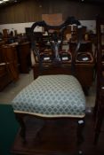 A Victorian mahogany salon chair having scroll and foliate back , later upholstered overstuffed seat