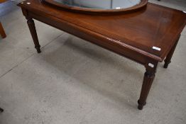 A reproduction mahogany coffee table in the classical style, width approx. 108cm