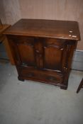A reproduction oak period style TV cabinet