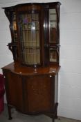 An Art Nouveau display cabinet , with inlaid decoration and coloured leaded glass display section