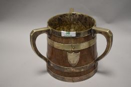 A late Victorian oak and silver plate tyg, of oversized proportions, having inscription to front