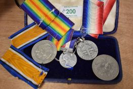 Four collectable souvenir coins/ medals, including 1981 Charles and Diana, 1977 Elizabeth and