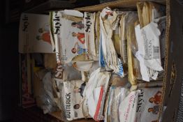 A box full of vintage sewing patterns.