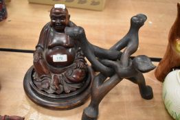 A carved hardwood Buddha on stand and a separate interlocked wooden stand.