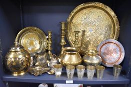 A selection of brass ware, including Indian Lassi cups, charger with traditional Indian scenes,