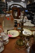 An early 20th century brass lamp on wooden base, having frosted glass shade with leaf decoration.