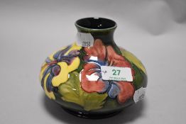 A mid century Moorcroft pottery Hibiscus pattern vase of squat form, having tube lined Hibiscus
